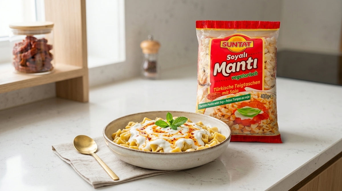 Paquet de Manti SUNTAT 400g à côté d'un bol de manti cuits nappés de sauce, sur un plan de travail de cuisine moderne